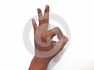 Hand showing the ok gesture isolated on a white background.