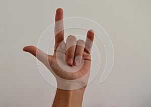 Hand showing the sign of rock`n`roll closeup isolated on white background