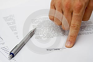 Hand showing signature place on contract