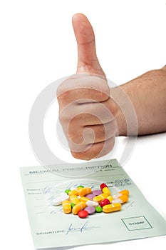 Hand showing thumbs up above a medical prescription
