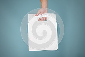 Hand shows blank plastic bag mock up isolated. Empty white polyethylene package mockup. Consumer pack ready for logo design or id