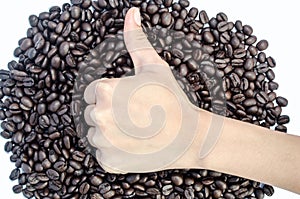 The hand shows thumbs up and coffee beans