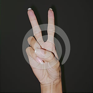 Hand sign defining victory at the past