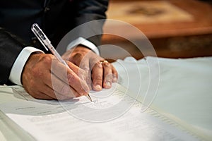 Hand signs the marriage register