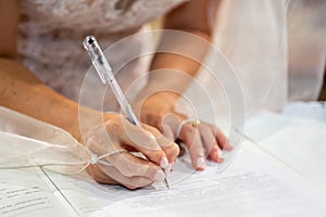 Hand signs the marriage register