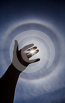 Hand silhouette with Circular Sun Halo