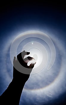 Hand silhouette with Circular Sun Halo