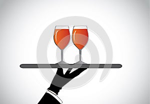 Hand silhouette presenting two stylish glasses with red wine