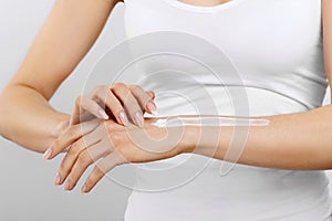 Hand Skin Care. Close Up Of Female Hands Applying Cream, Lotion. Beautiful Woman Hands With Red Manicure. Nails Applying Cosmetic