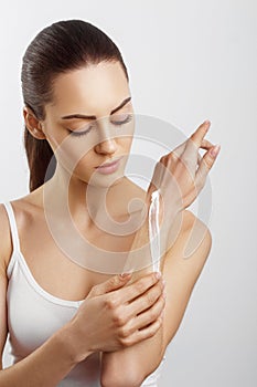 Hand Skin Care. Close Up Of Female Hands Applying Cream, Lotion. Beautiful Woman Hands With Red Manicure. Nails Applying Cosmetic