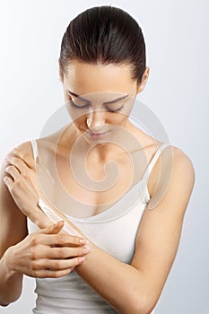 Hand Skin Care. Close Up Of Female Hands Applying Cream, Lotion. Beautiful Woman Hands With Red Manicure. Nails Applying Cosmetic