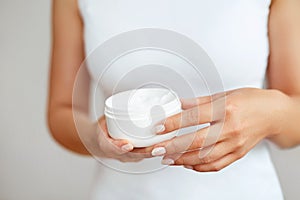 Hand Skin Care. Close Up Of Female Hands Holding Cream Tube, Beautiful Woman Hands With Natural Manicure Nails