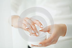 Hand Skin Care. Close Up Of Female Hands Holding Cream Tube, Beautiful Woman Hands With Natural Manicure Nails Applying Cosmetic