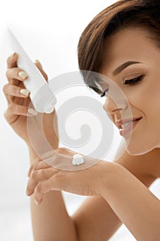 Hand Skin Care. Closeup Of Beautiful Woman Applying Cream