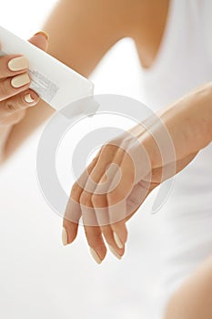 Hand Skin Care. Closeup Of Female Hands Holding Cream Tube