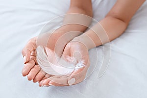 Hand Skin Care. Woman Hands With Soft White Feather. Body Care