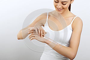 Hand Skin Care. Women use body lotion on your arms. Female applying cream to her hands