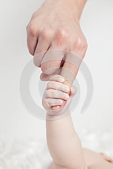 Hand the sleeping baby in the hand of mother close up, gentle soft focus