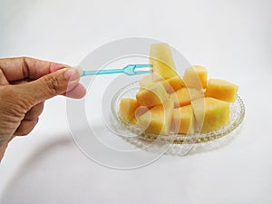 Hand and sliced cantaloupes.