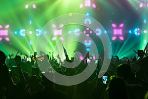 Hand with a smartphone records live music festival Taking photo of concert stage live concert music festival happy youth luxury