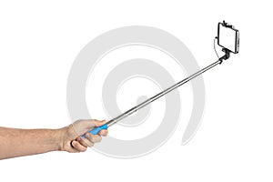 Hand and smartphone with selfie stick