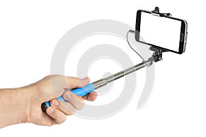 Hand and smartphone with selfie stick photo