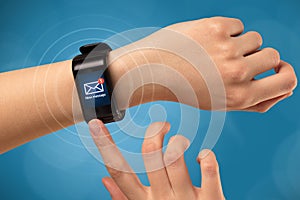 Hand with smartwatch and blue background