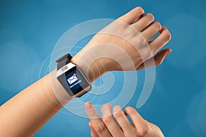 Hand with smartwatch and blue background