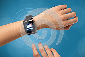 Hand with smartwatch and blue background