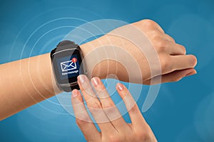 Hand with smartwatch and blue background