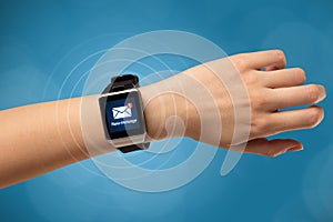 Hand with smartwatch and blue background