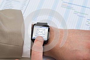 Hand with smartwatch showing unread message