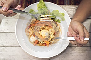 Hand with spicy spaghetti with Tom Yum Seafood