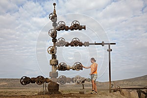 Hand spinning wheel on oil pipeline in Azerbaijan desert