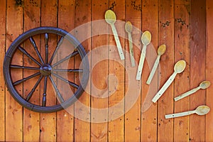 Hand spinning wheel on the wall of the old log house