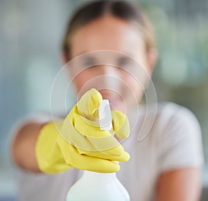 Hand, spray bottle and cleaning with a woman in gloves for housework or sanitization for hygiene. Hands, latex and