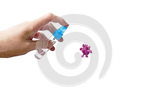 Hand spraying alcohol or gel sanitized to purple coronavirus or COVID-19 sculpture by clay on white background