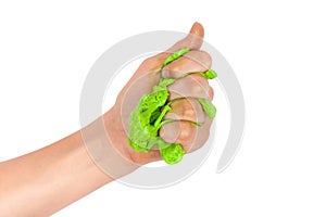 Hand squeezing green slime. Isolated on white background