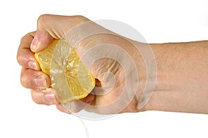 Hand squeezing a lemon