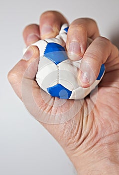 Hand squeezing the stress ball