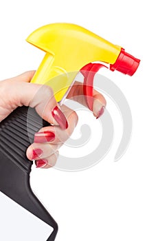 Hand squirting a bottle of cleaning spray photo