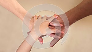 Hand stack of parents and child, teamwork and togetherness, family values