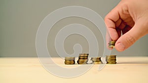 Hand stacking coins. Saving money, managing home budget.