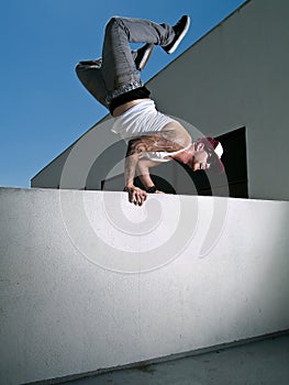 Hand stand over a wall