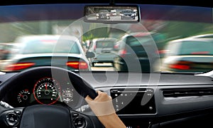 Hand on steering wheel during traffic jam