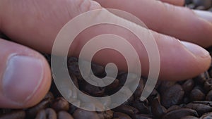 Hand stirring coffee beans
