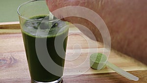 A Hand Stirring Organic Celery Powder with Aloe Vera Juice