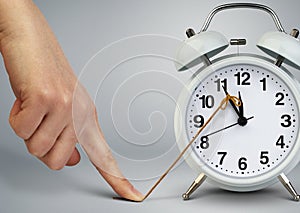 Hand stop time on alarm clock, deadline concept