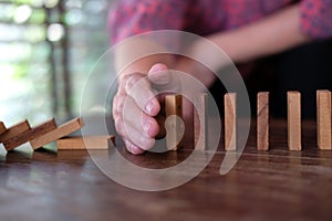 Hand stopping effect of domino continuous toppled. woman protect