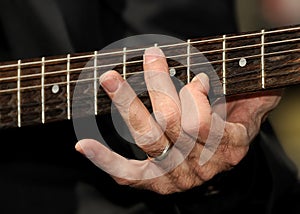 Hand strumming guitar strings